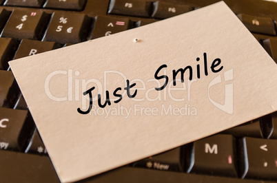 Just smile concept on keyboard background