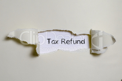The word tax refund appearing behind torn paper.