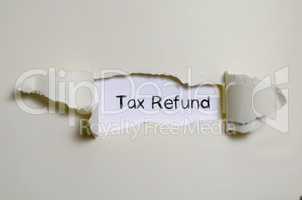 The word tax refund appearing behind torn paper.