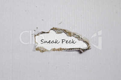 The word sneak peek appearing behind torn paper.