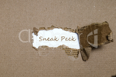 The word sneak peek appearing behind torn paper.