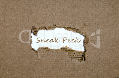 The word sneak peek appearing behind torn paper.