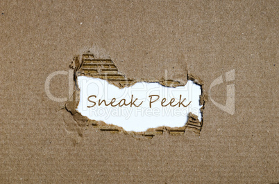 The word sneak peek appearing behind torn paper.