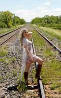 Young woman standing on railroad track's.