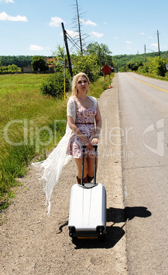 Young woman walking along street.