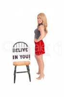 Beautiful woman with sign "believe in you".