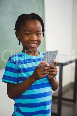 Schoolboy using mobile phone in classroom