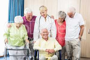 Nurse and seniors standing together