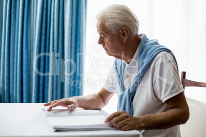 Senior man using braille to read