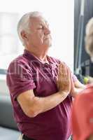 Seniors doing yoga with closed eyes