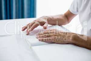 Senior man using braille to read