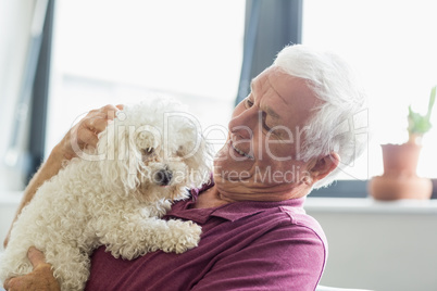 Senior man holding a dog