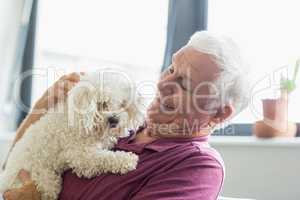 Senior man holding a dog