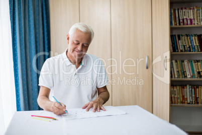 Senior man using a colouring book