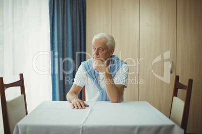 Senior man sitting at a table