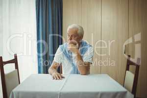Senior man sitting at a table