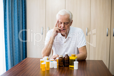 Senior sitting in front of medicine