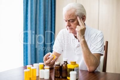Senior sitting in front of medicine