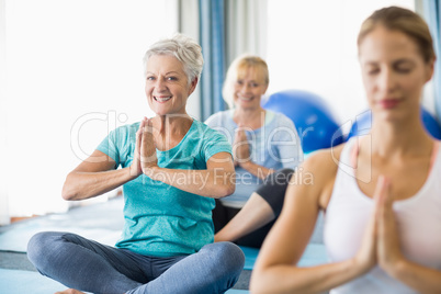 Instructor performing yoga with seniors