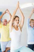 Instructor performing yoga with seniors