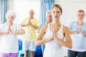 Instructor performing yoga with seniors