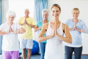 Instructor performing yoga with seniors