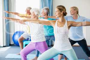 Instructor performing yoga with seniors