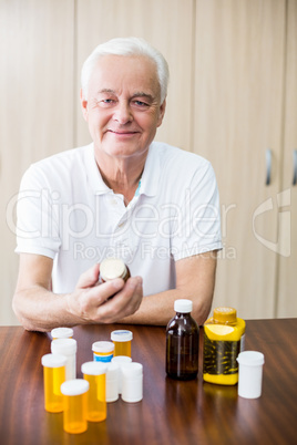 Senior sitting in front of medicine