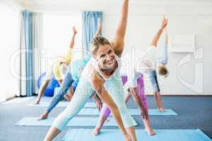 Instructor performing yoga with seniors