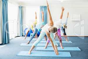 Instructor performing yoga with seniors