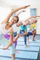 Instructor performing yoga with seniors