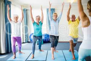 Instructor performing yoga with seniors