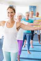 Instructor performing yoga with seniors