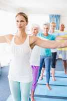 Instructor performing yoga with seniors