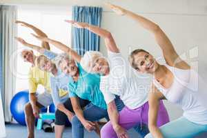 Instructor performing yoga with seniors