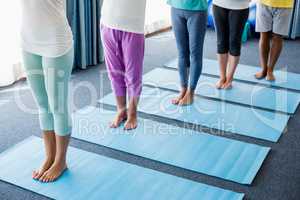 Instructor performing yoga with seniors