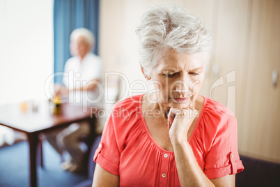 Thoughtful senior woman touching her chin