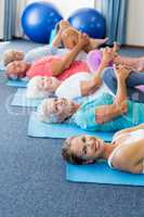 Instructor performing yoga with seniors