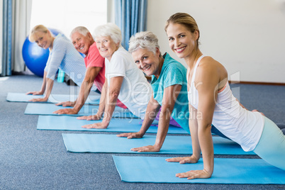 Instructor performing yoga with seniors