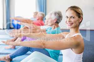 Instructor performing yoga with seniors