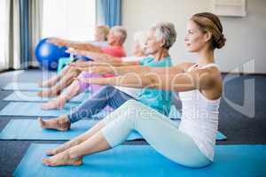 Instructor performing yoga with seniors