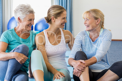 Instructor and senior women sitting