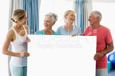 Instructor and seniors holding a poster