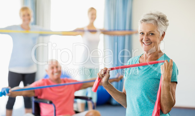 Seniors exercising with stretching bands