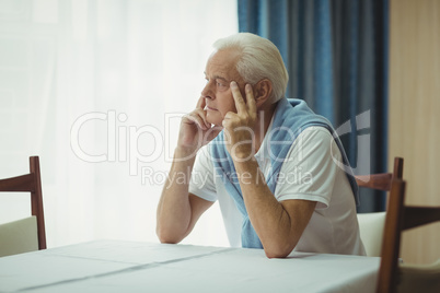 Senior man sitting at a table