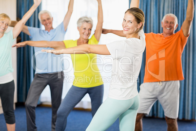 Instructor doing exercises with seniors