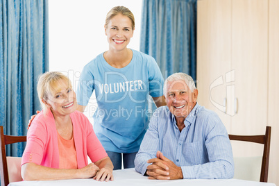 Volunteer taking care of senior couple