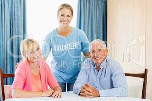 Volunteer taking care of senior couple