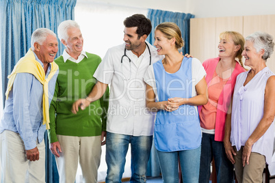 Nurse and seniors standing together