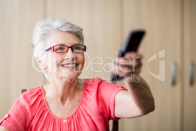 Senior woman using a remote control